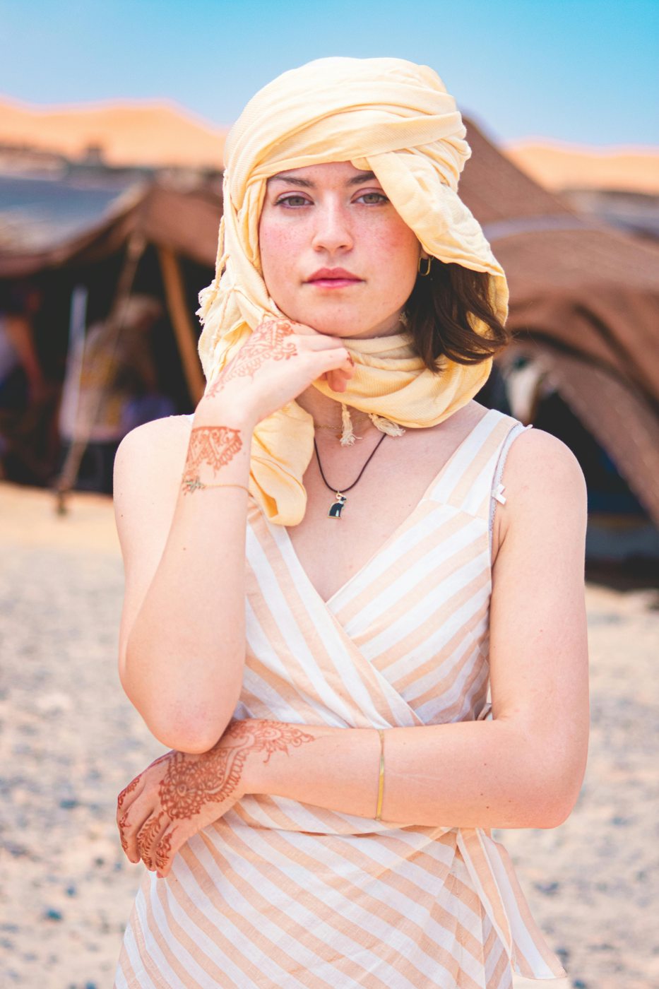 A traveler wearing a traditional headscarf in the Merzouga desert